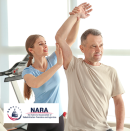 Physical Therapist stretching a patient's arm upwards