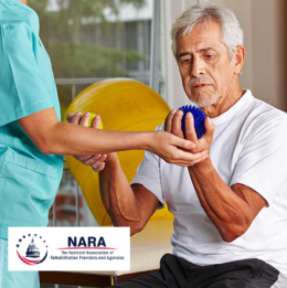 Older man holding stress balls while working with occupational therapist