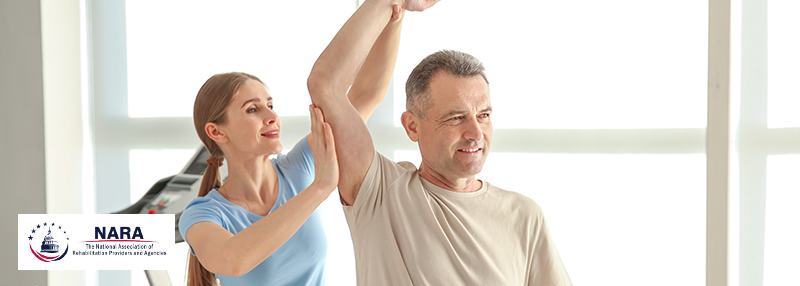 Physical Therapist stretching a patient's arm upwards