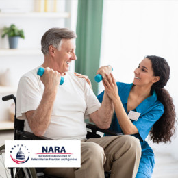 Older adult male using weights during a physical therapy session with a therapist