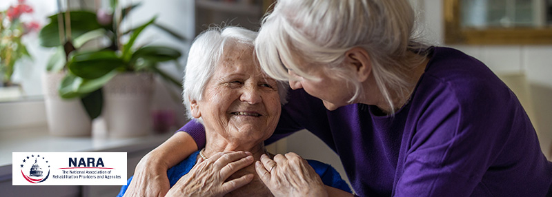 Older adult woman comforting her mother while sitting on the couch